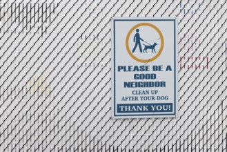 Sign reminds dog owner to clean up after their dog