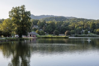 Youth paddles his paddleboard away from Lake Junaluska Outfitters launch in Lake Junaluska, North