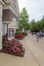 Sign for the Showstreet Ice Cream show surrounded by flowers at the Dollywood amusement park in