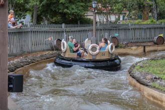 Park guests ride the Smoky Mountain River Rampage at the Dollywood amusement park in Pigeon Forge,