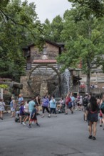 Park guests walking past the Dollywood Grist Mill at the Dollywood amusement park in Pigeon Forge,