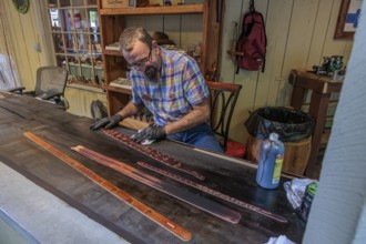 Craftsman demonstrated the art of belt making in Smoky Creek Leather and Hat Company at the