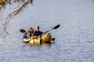 Senior couple paddleing a an inflatable kayak on Archusa Creek Lake at Archusa Creek Water Park