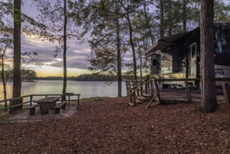 Motorhome parked on the shores of Archusa Creek Lake at sunset in Archusa Creek Water Park near