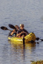 Senior couple paddleing a an inflatable kayak on Archusa Creek Lake at Archusa Creek Water Park