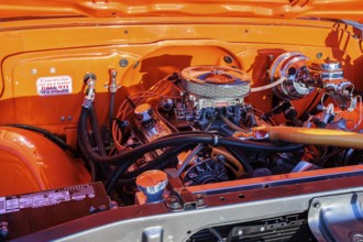 Engine of a classic Chevrolet pickup truck with Eldebrock carburetor and chrome breather