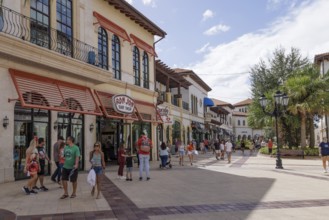 Shoppers and visitors walking past Ron Jon Surf Shop in Disney Springs at Disney World in Orlando,