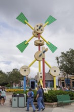 Shoppers and visitors walking past a Tinkertoy sculpture display in Disney Springs at Disney World