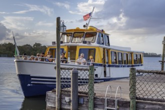Water taxi boat with passengers approaching the dock of Fort Wilderness campground at Walt Disney