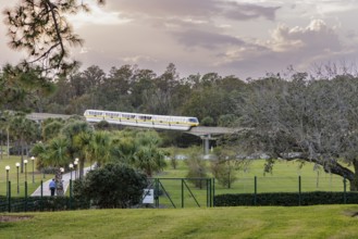 Monorail carries passengers toward the entrance to the Magic Kingdom at Walt Disney World in