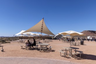 Umbrella shaded tables and a large awning provide visitors shade from the desert sun at Eagle Point
