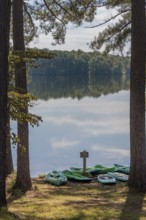 Plastic rental kayaks, canoes and paddleboards on the shore of Pin Oak Lake at The Lodge hotel in