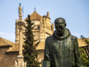 Statue of Johannes von Gott, Granada, royal hospital in the back, Granada, Andalusia, Spain