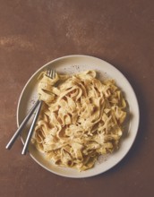 Fettuccine, tagliatelle, in creamy garlic sauce, Italian traditional cuisine, pasta carbonaro