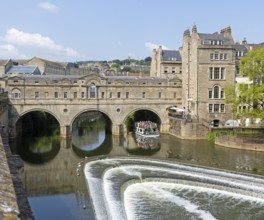 Boat trip at Pulteney Bridge, River Avon weir, city of Bath, north east Somerset, England, UK