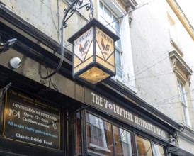 Vintage Courage pub lamp sign outside The Volunteer Rifleman's Arms pub, city of Bath, north east