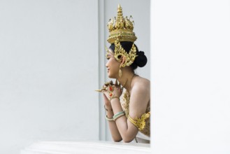 Thai traditionally and festively dressed young woman, Wat Pho, Bangkok, Thailand