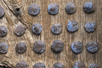 Old wooden door with rusty metal rivets at regular intervals, North Macedonia, Balkans