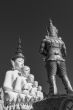 Five-headed Buddha statue with a temple guard in front of it, black and white photo, Wat Phra That