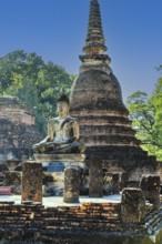 Stone Buddha statue and historic temple tower, Prang, historical park, Sukhothai, Sukhothai