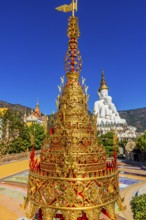 Gilded chedi, the five-headed Buddha statue in the back, Wat Phra That Sorn Kaew Buddhist temple