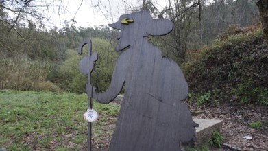 Wooden figure of a pilgrim on the side of the Camino de Santiago, pilgrims on the Caminho