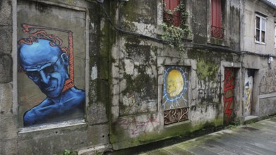 Graffiti on an old building wall with blue figure and other drawings, pilgrims on Caminho