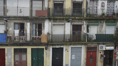 Façade of an old building with several balconies and shutters, Porto, Portugal