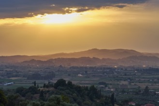 Fields and hills in the distance under a glowing sky at sunset, Hotel Europa, garden restaurant and