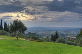 Wide landscape with a focus on a cloudy sky and isolated trees, Hotel Europa, garden restaurant and