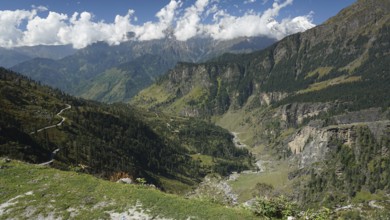 View of winding mountain roads on the Manali-Leh Highway and green slopes, trekking Ladakh,