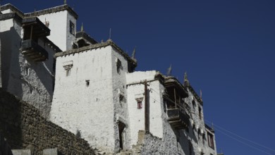 Close-up of the facade of Thiksey Buddhist monastery with deep blue sky, trekking in Ladakh,