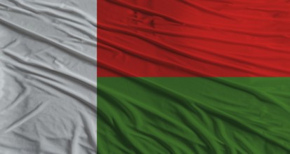 Malagasy flag waving. Flag of Madagascar with cloth texture