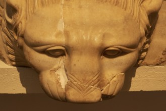 Stone sculpture of a lion's head, detailed view with light and shadow, Olympia Archaeological