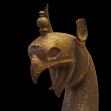 Bronze griffin protome, detailed bronze image of a mythological being with decorative headdress,