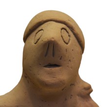 Anthropomorphic votive statuette, abstract clay figure with indicated headdress and simple details,