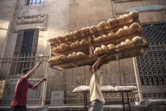 Cairo, Egypt. July 3rd 2024 Freshly baked Baladi bread being delivered by bicycle to a street stall