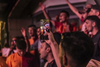 Istanbul, Turkey. October 24th 2023 Galatasaray football fan with a cell phone while chanting songs