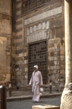 Cairo, Egypt. July 7th 2024 An Egyptian man wearing traditional clothes walks along the cobbled
