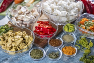 Various fresh ingredients such as peppers, carrots, rice and spices