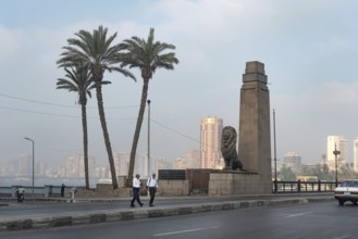 Cairo, Egypt. July 1st 2024 Two Egyptian men cross the Qasr El Nil Bridge during the early morning