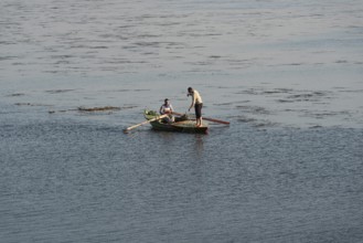 Qanater, Nile Delta. Egypt. December 18th 2022 Egyptian fishermen fishing from a small boat on the