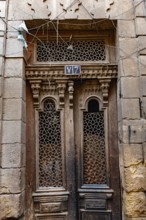 Cairo, Egypt. December 21st 2022 An antique wooden door of a house in the narrow alleyways of the