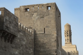 Minaret of the Al Hakim Mosque with the fortified defensive Northern walls of Islamic Cairo, near