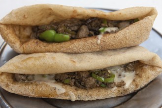 A plate of tasty fried liver and spicy green pepper sandwiches, one of the most popular street food