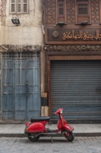 Cairo, Egypt, November 26th 2022 Very cool red Vespa motor scooter parked in the Islamic quarter of