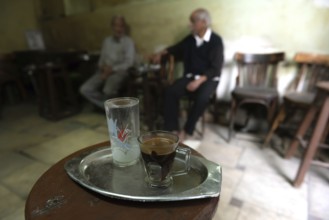 Cairo, Egypt. November 27th 2022 Traditional glass of Egyptian Arabic coffee on a tray in a local
