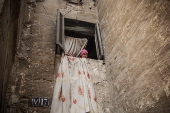 Cairo, Egypt. March 13th 2006 A young Egyptian girl in the window of a house in a poor neighborhood