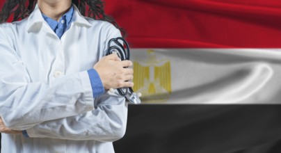 Healthcare professional with Egypt flag background. Professional doctor holding stethoscope on