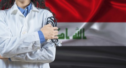 Healthcare professional with Iraq flag background. Professional doctor holding stethoscope on Iraq